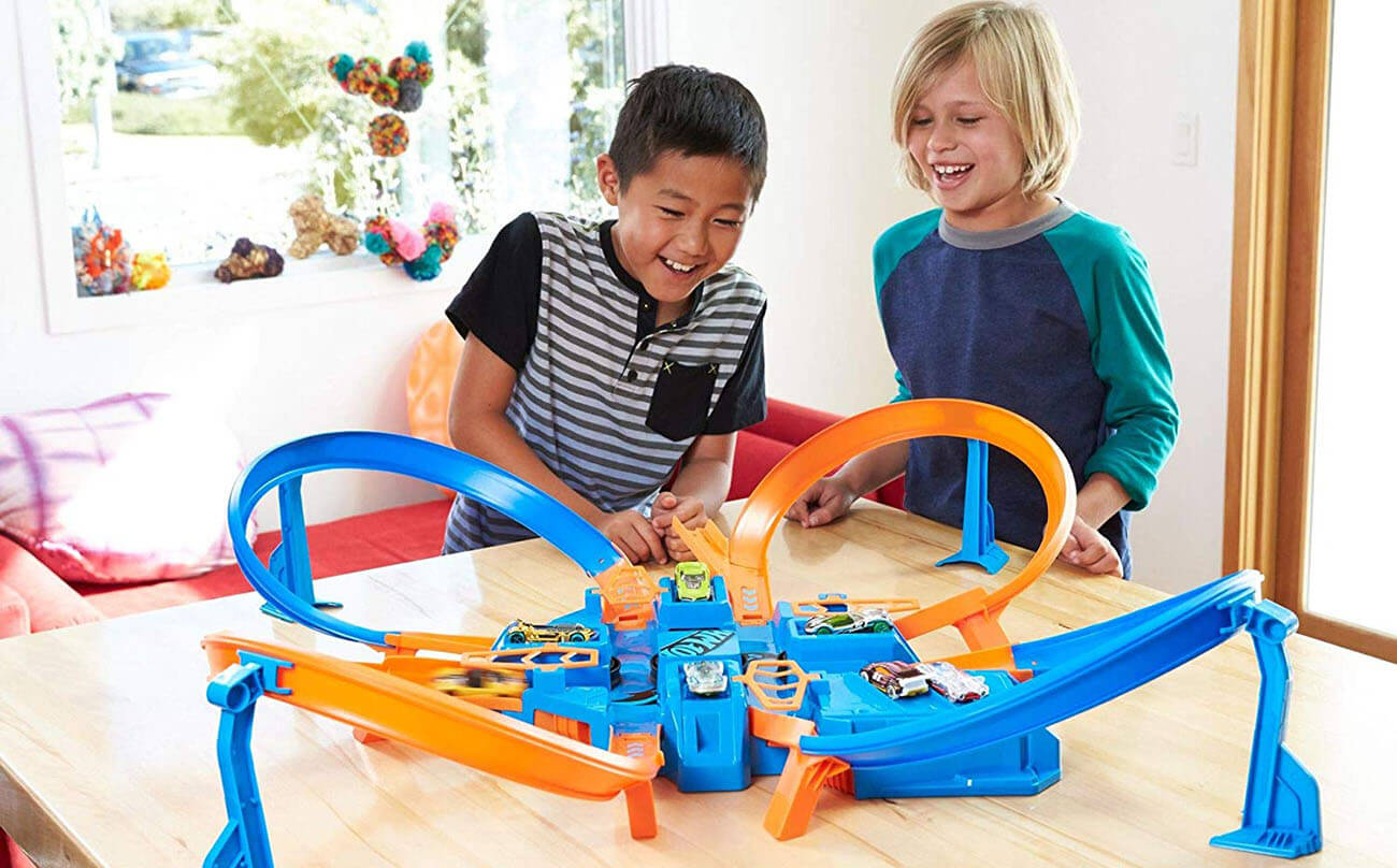 Two boys playing with Hot Wheels