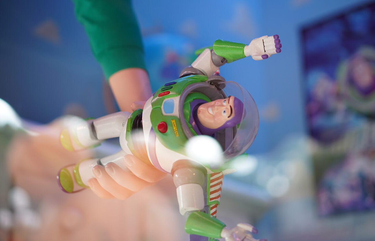 7 year old boy holding Buzz Lightyear toy