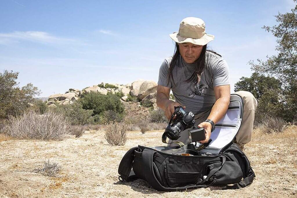 photographer opening a camera backpack