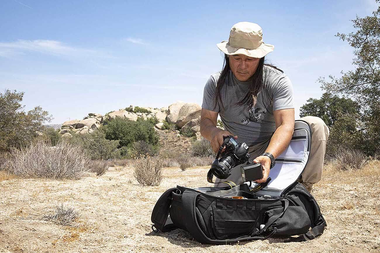 photographer opening a camera backpack