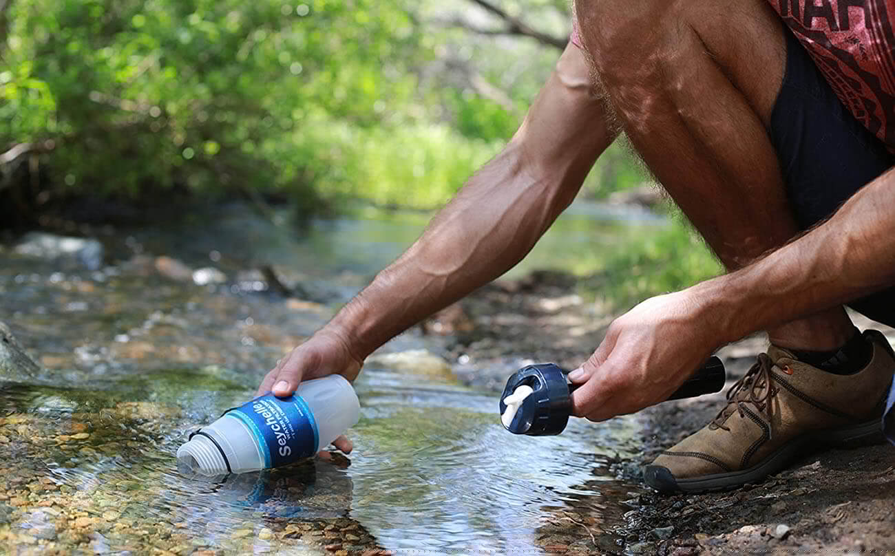 Filling up a Filtered Water Bottle on a river