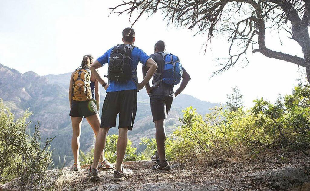 Three hikers wearing Hydration Packs
