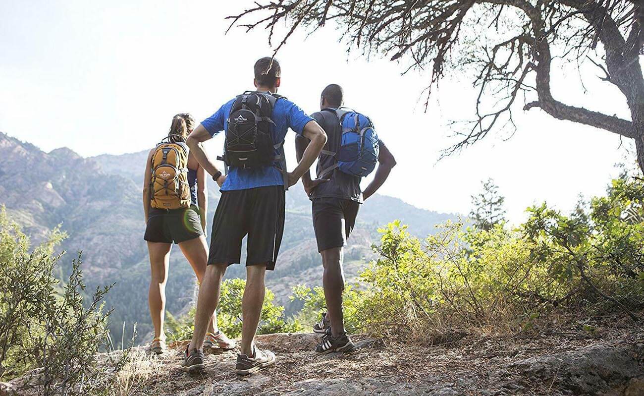 Three hikers wearing Hydration Packs