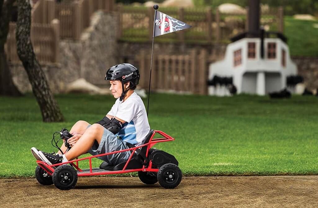 Kid on an electric car in the yard