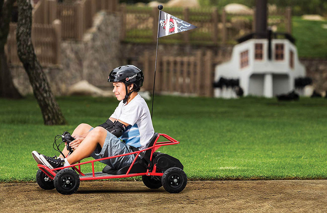 Kid on an electric car in the yard