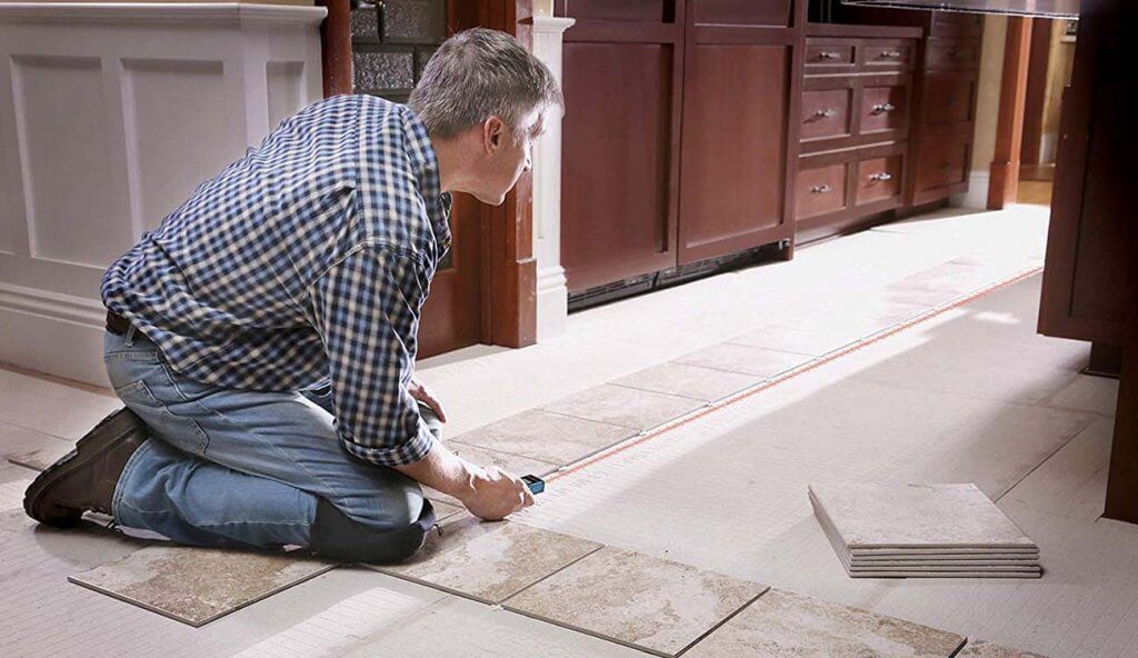 Bosch BLAZE Laser Distance Measurer used for placing tiles in a straight line