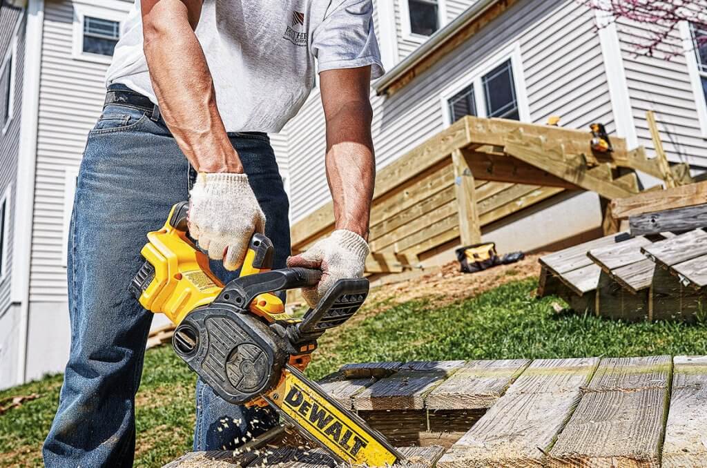 DEWALT DCCS620P1 Compact Electric Chainsaw cutting top down