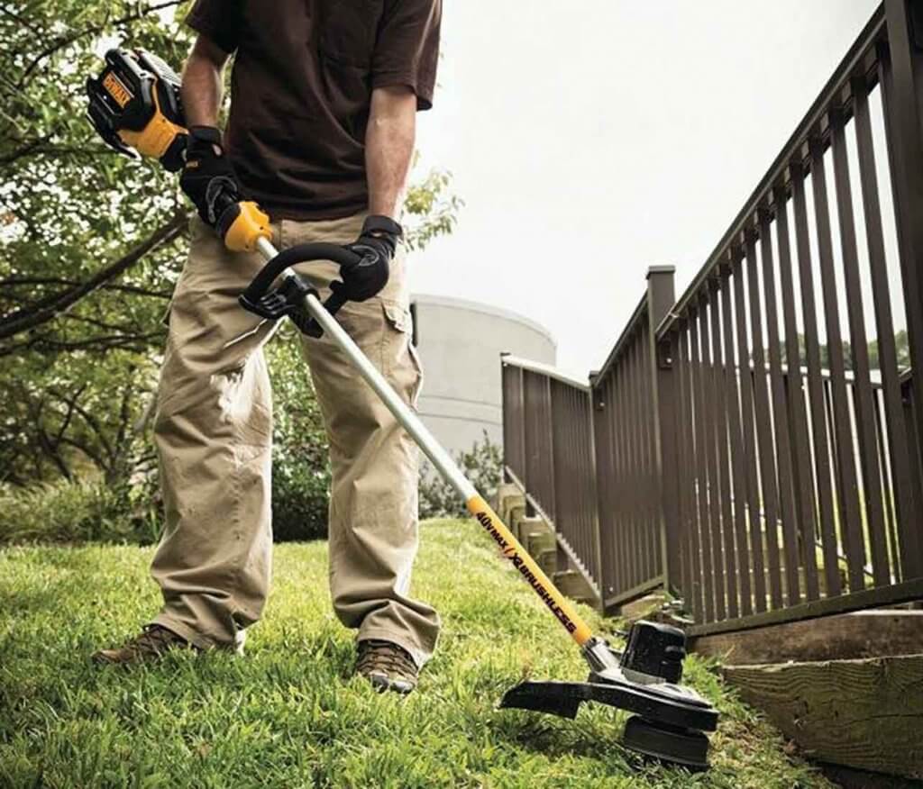 DEWALT DCST990H1 40V MAX 6.0Ah Lithium Ion XR used cutting edge next to a fence