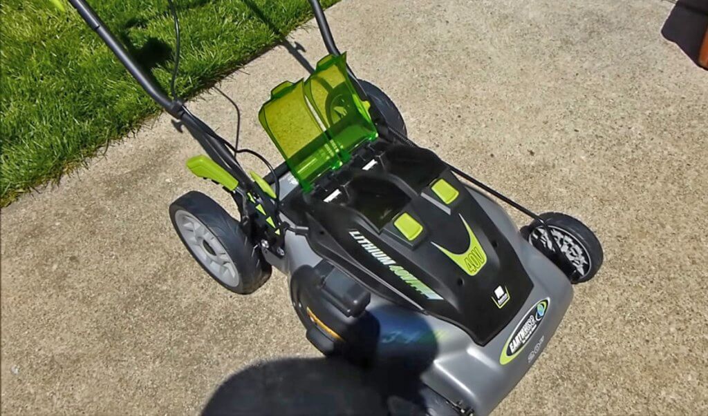 Earthwise 20-Inch Cordless Lawn Mower in front of garage