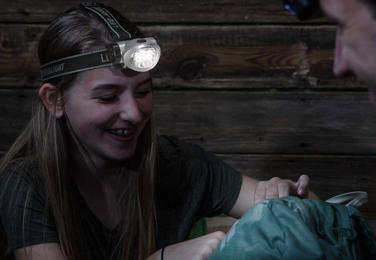 Girl using the EverBrite 2-Pack Headlamp on a camping trip