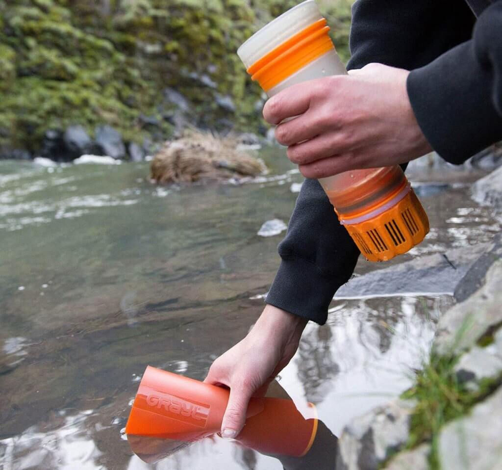 Filling up the GRAYL Ultralight Water Purifier Bottle on a river