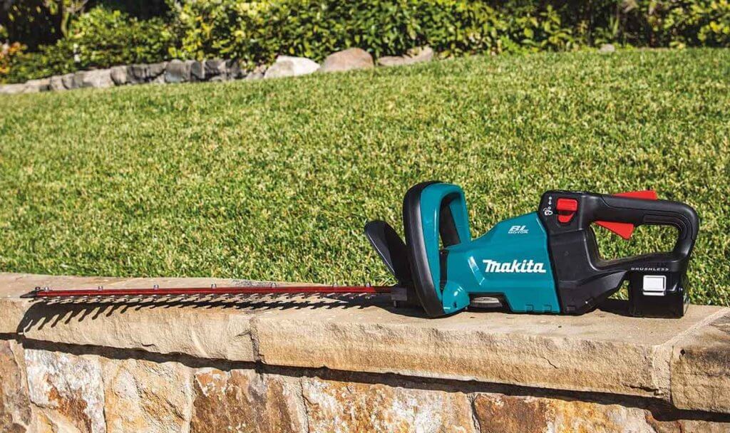 Makita XHU08T Hedge Trimmer on a garden wall