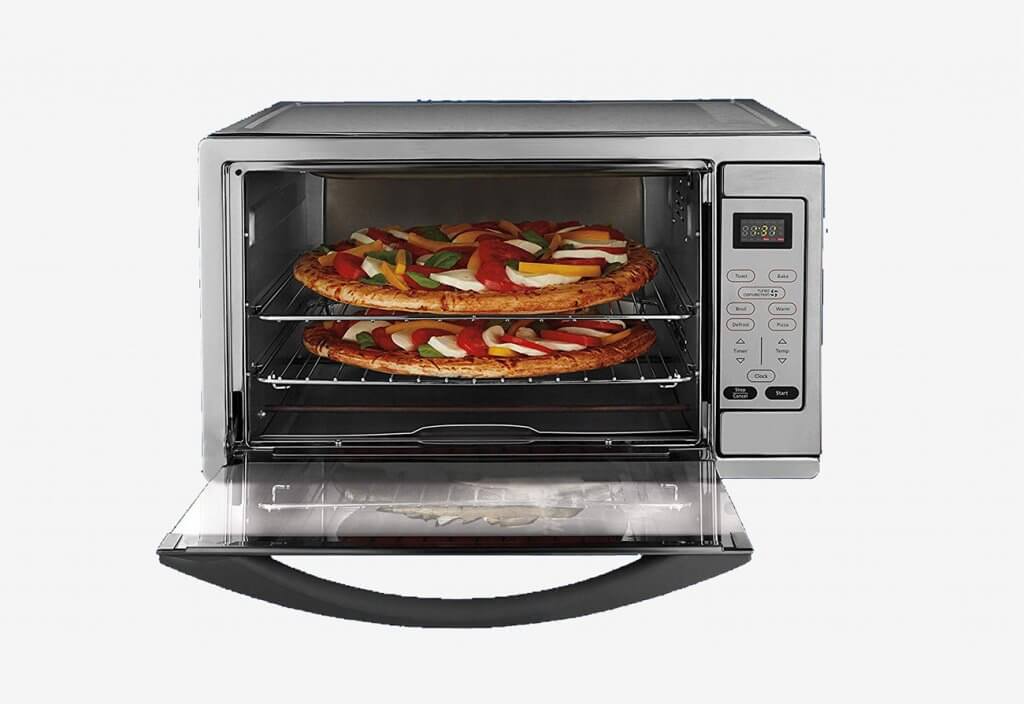 Preparing pizza in the Oster Extra Large Stainless Steel Oven