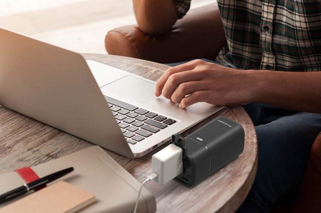 RAVPower AC Outlet External Battery Pack next to MacBook