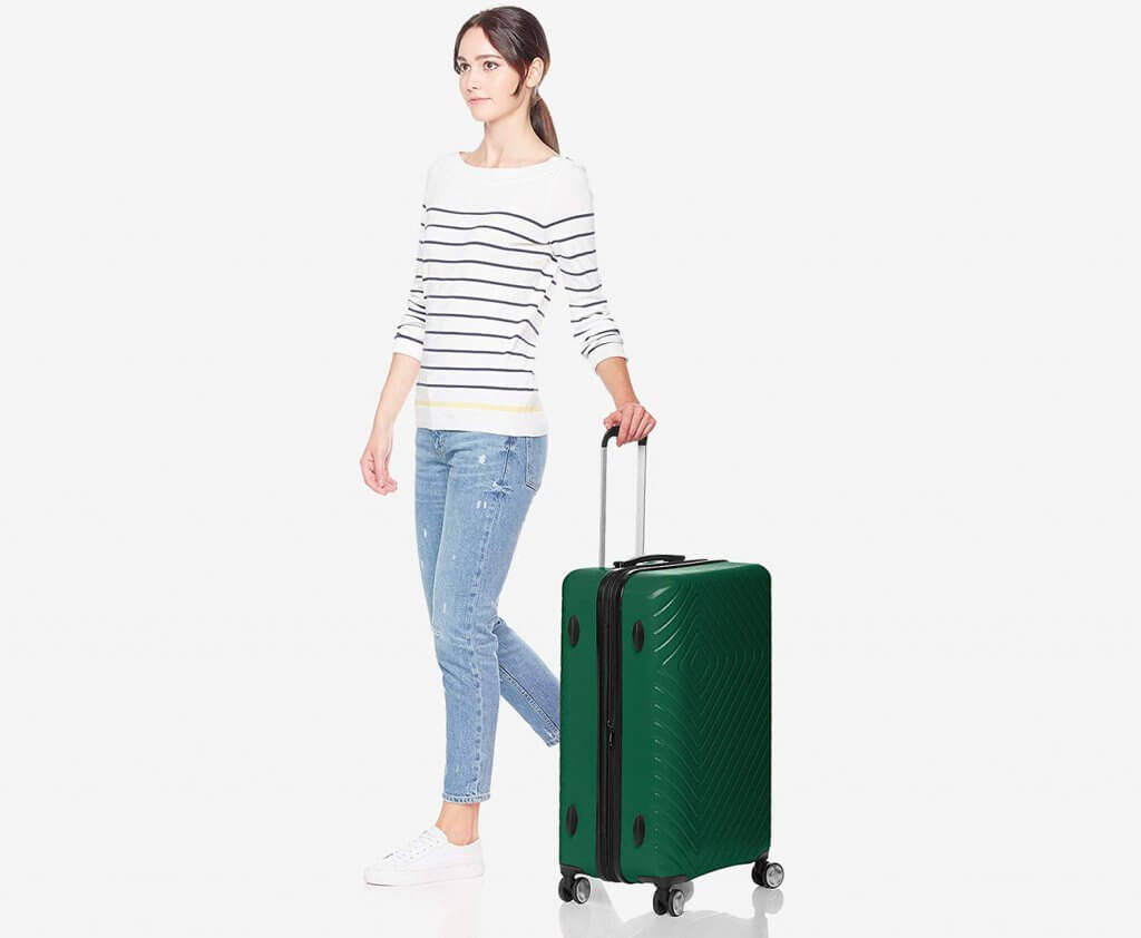 Someone carrying the AmazonBasics Luggage set