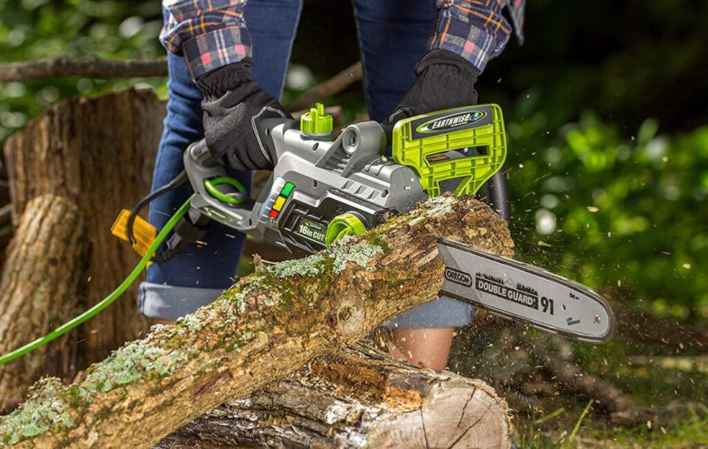 Someone using the Earthwise CS33016 Electric Chainsaw to cut a log