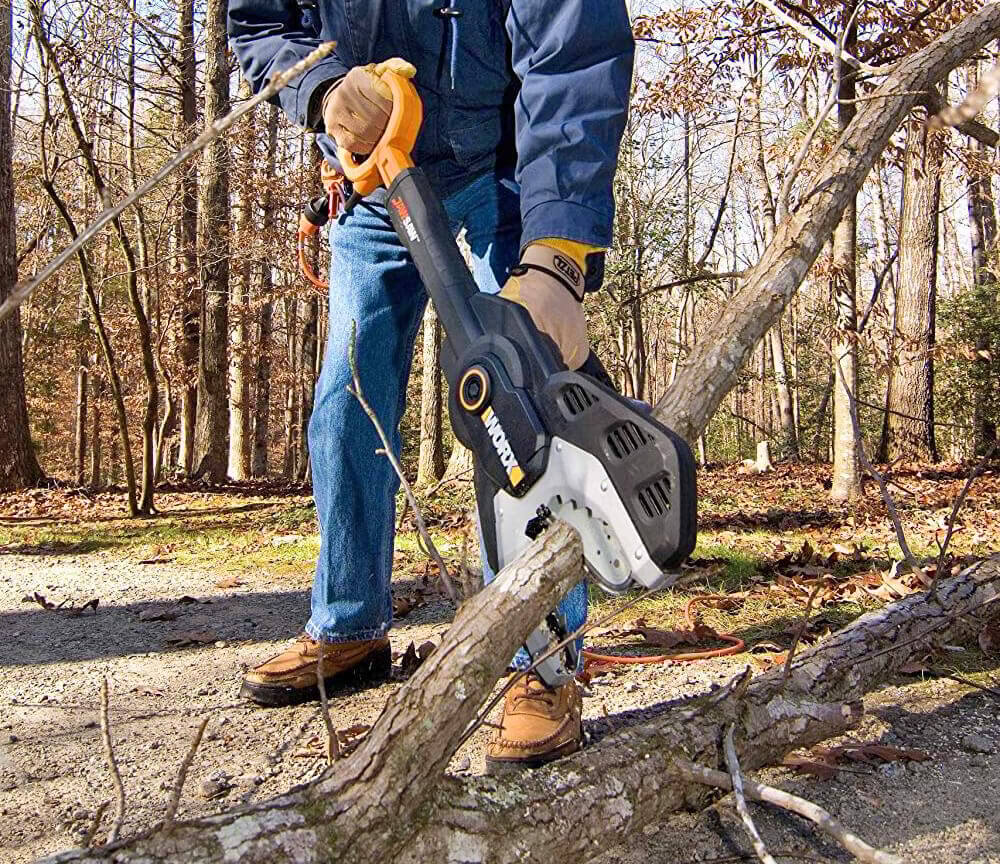 Someone using the WORX WG307 to clear a path