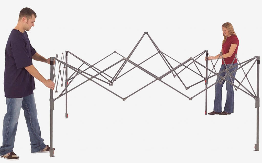 Two people setting up the Coleman Canopy Tent