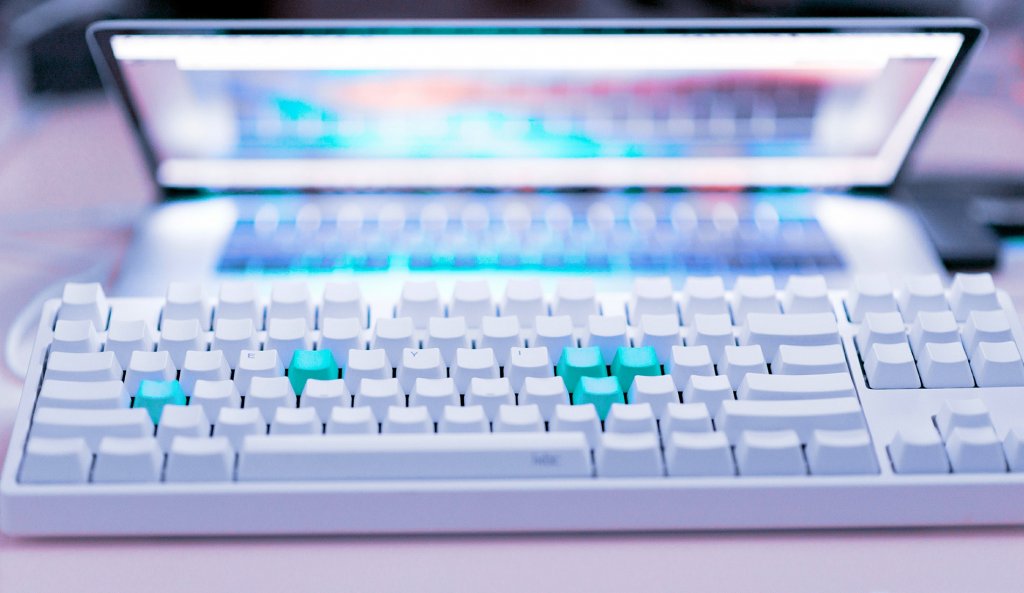 White wireless keyboard and Macbook