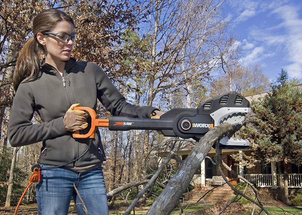 Woman using the WORX WG307 JawSaw Electric Chainsaw to cut down a branch