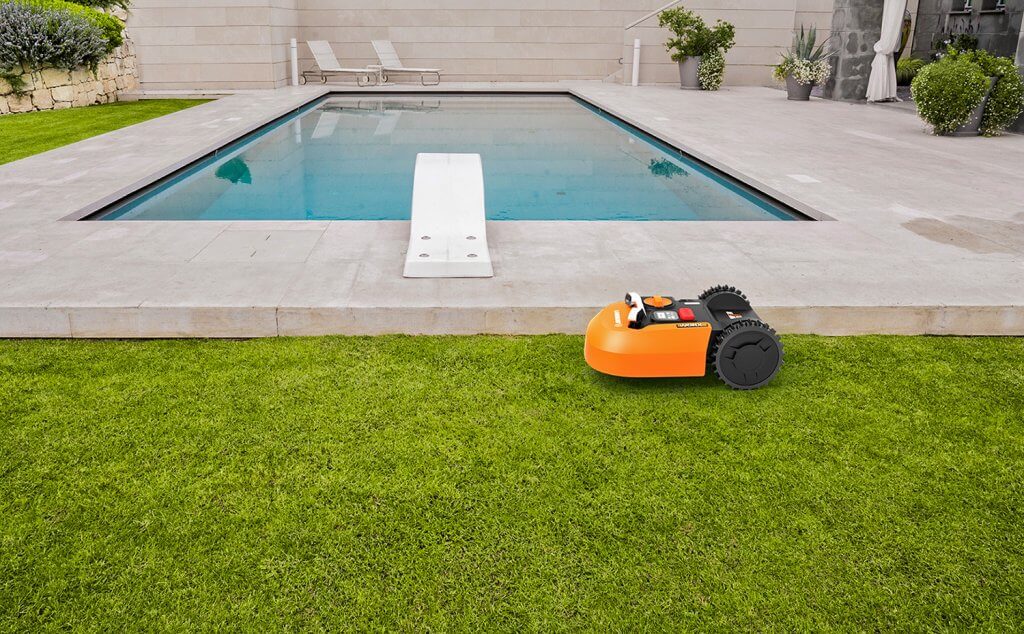 WORX Landroid WR150 in the lawn next to a pool